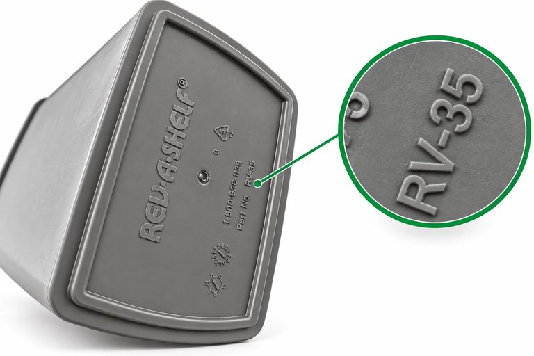 Underside of a Rev-A-Shelf RV-35 pull-out trash bin, with a magnified close-up of the moulded Part No. RV-35 stamp