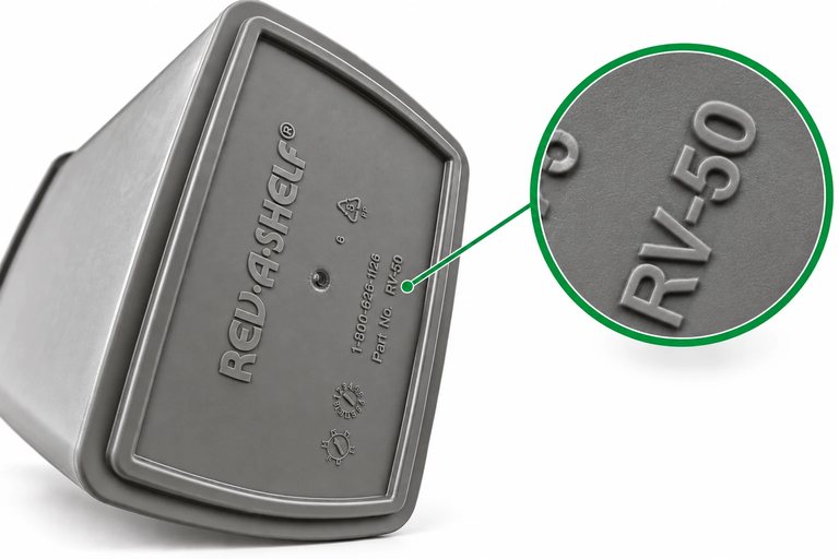 Underside of a Rev-A-Shelf RV-50 pull-out trash bin, with a magnified close-up of the moulded Part No. RV-50 stamp